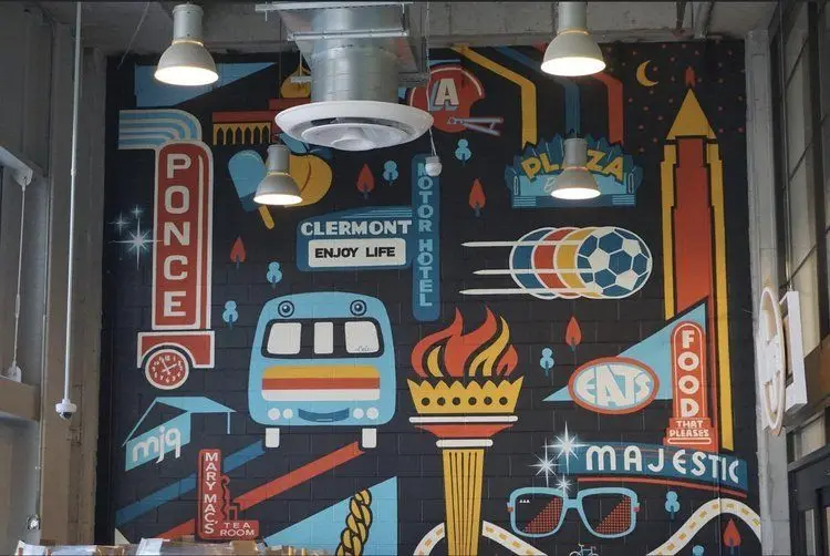 Hand-painted city mural covering an interior wall